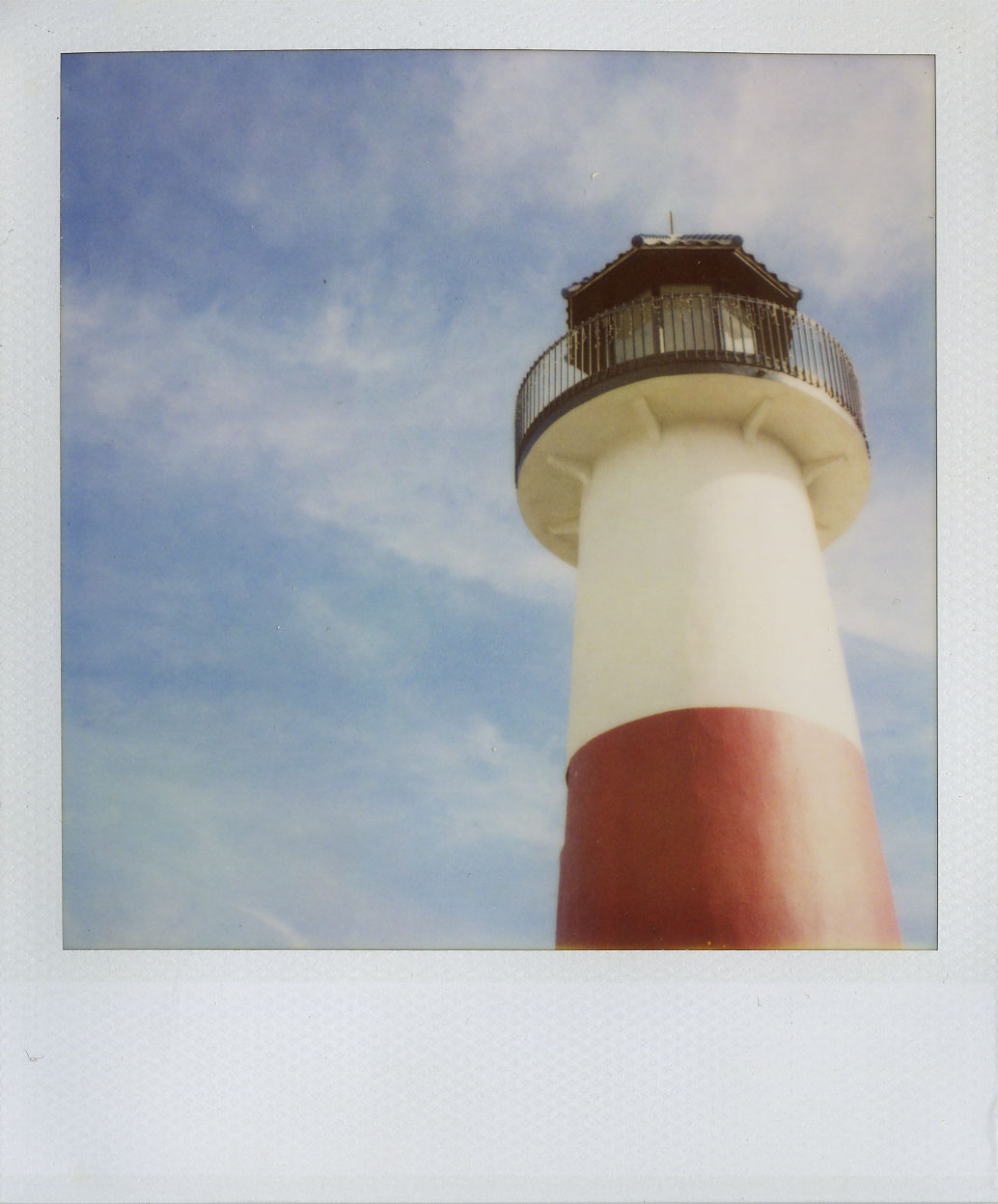 polaroid lighthouse at the ocean